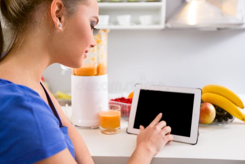 Young Woman Using Tablet in Kitchen Stock Image Image of horizontal