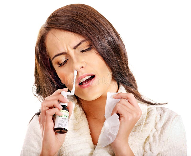 Young woman using throat spray. royalty free stock image