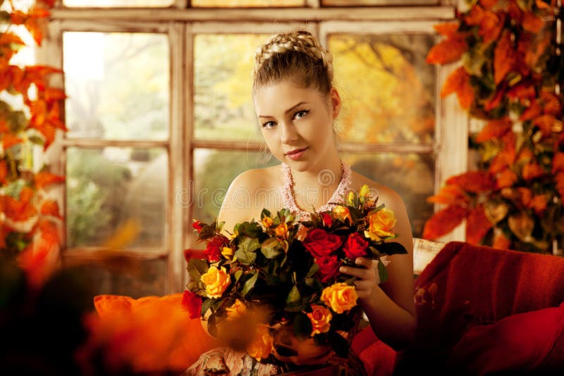 Young woman in vintage dress on autumn porch. Beauty girl in fa