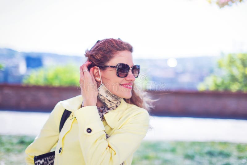Young woman walking at park during springtime, pandemic over, mask down stock photography Young woman walking at park during springtime, pandemic over, mask down stock photography