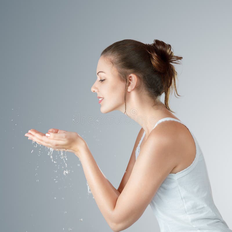 Young woman washing face