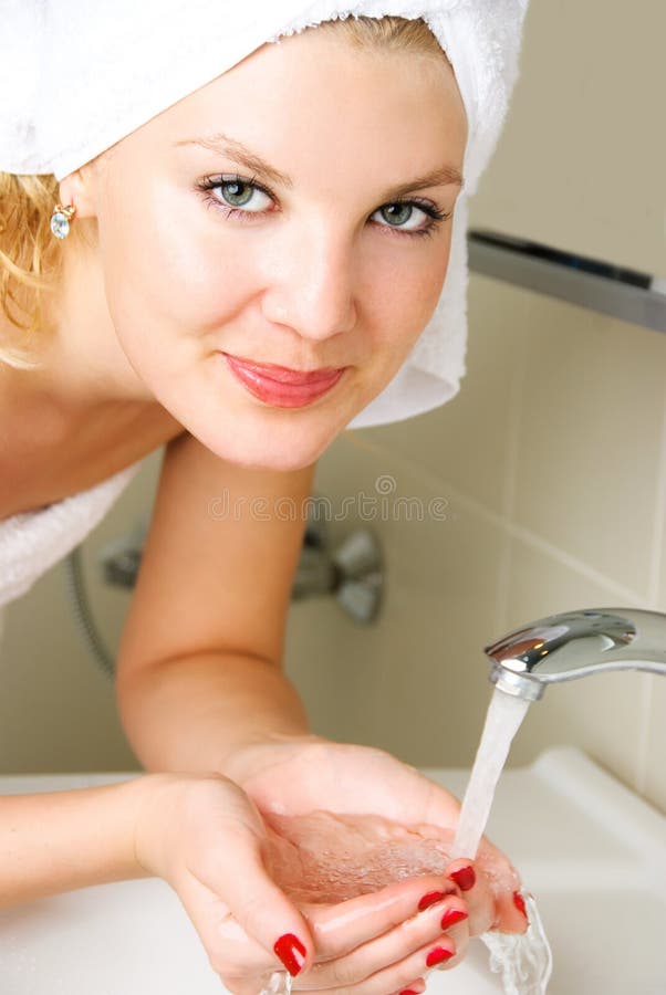 Young woman washing her face