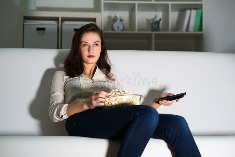 Young woman watching TV