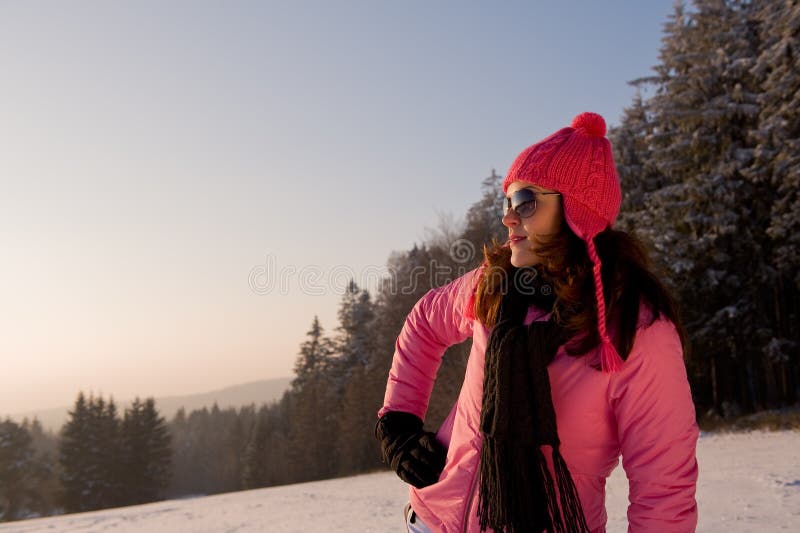 Young woman watching winter sunset