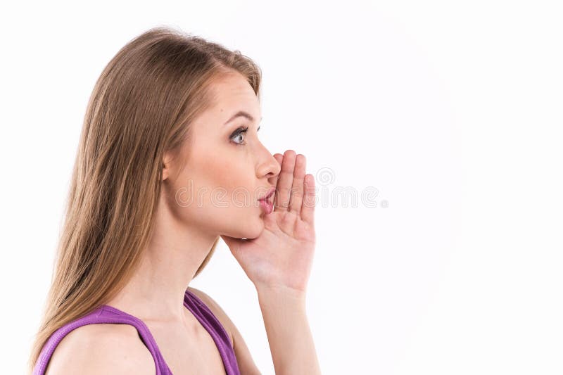 Young woman whispering over white background.