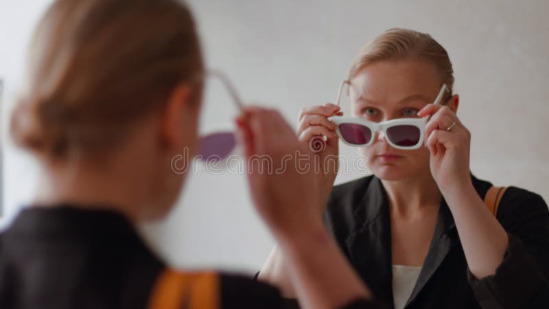 A young woman in white-framed sunglasses