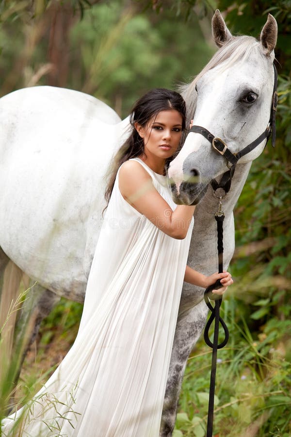 Young Woman with White Horse stock photo