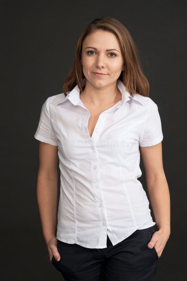 Young Woman in a White Shirt Against Grey Background Stock Photo ...