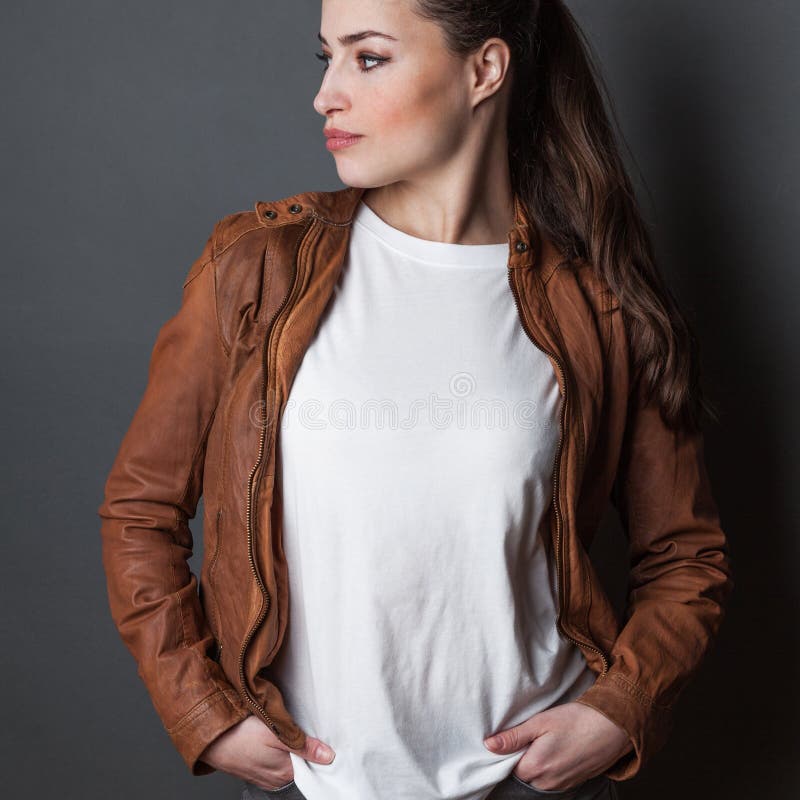 Young woman in white t-shirt and brown leather jacket studio shot, t shirt mock up stock photography