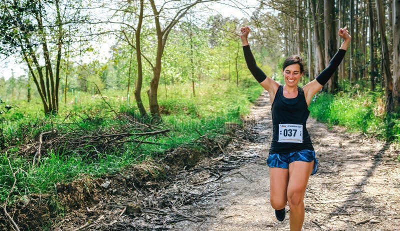 Young woman winning trail race stock photos