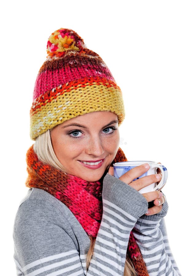 Young woman in winter clothing drinking from a mug. Vertically framed shot. Young woman in winter clothing drinking from a mug. Vertically framed shot.