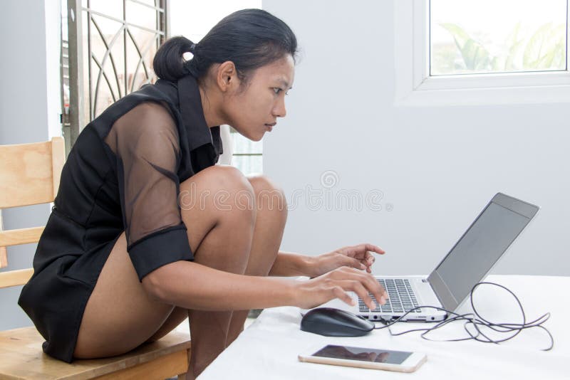 A young woman working on her laptop on the bed. stock images A young woman working on her laptop on the bed. stock images