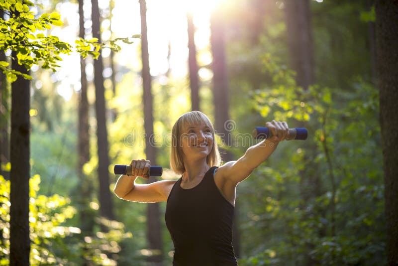 Young woman working out with weights