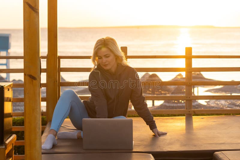 Young Woman Working, Using Laptop Computer on a Beach. Freelance Work