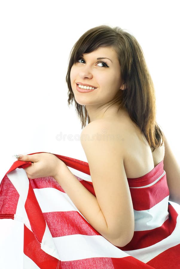 Young woman wrapped into the American flag