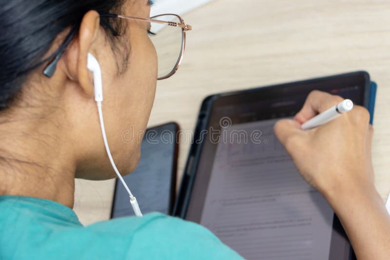 A young woman writes on a tablet, top view stock photos