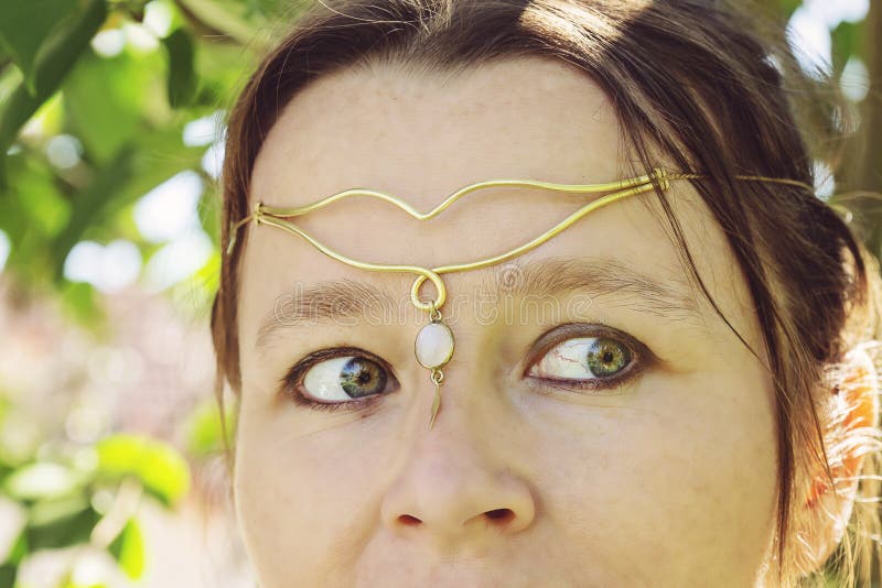 Young womans head wearing romantic metal tiara on her forehead stock photo Young womans head wearing romantic metal tiara on her forehead stock photo
