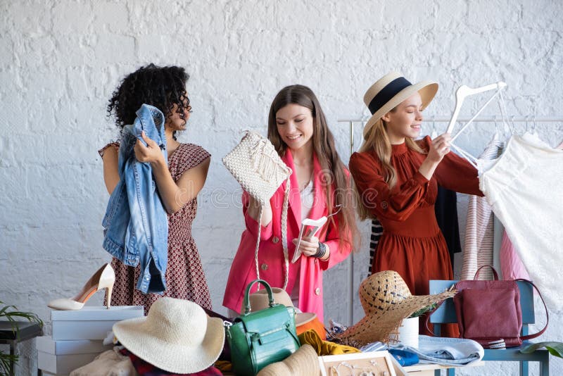 Young Women Choose Things at Flea Market. Casual Clothes, Shoes, Hats ...