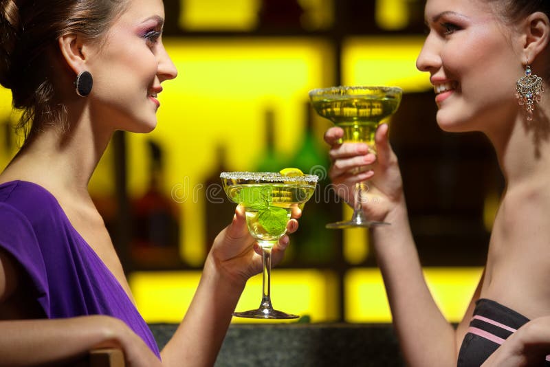 Young women drinking at bar