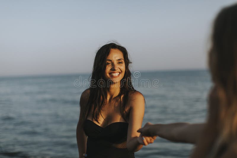 Young women having fun at summer vacations on the beach