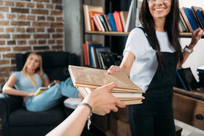 Young women holding books at home library stock photos Young women holding books at home library stock photos