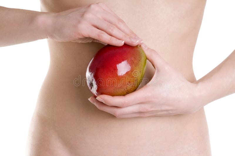 Young women with mango fruit in spa