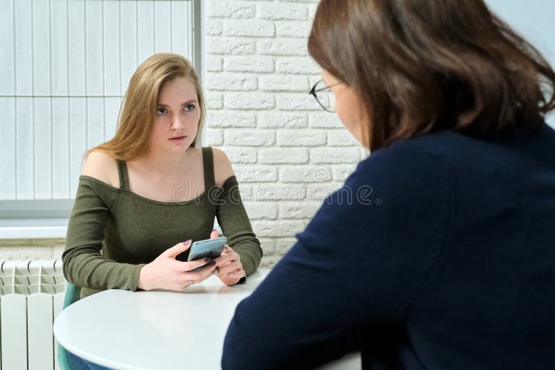 Young women in meeting with female psychologist, girl student telling her problems therapist, mental health of youth. Young women in meeting with female psychologist, girl student telling her problems therapist, mental health of youth