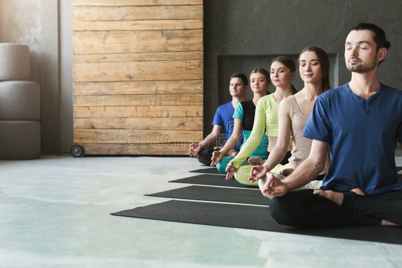 Young Women and Men in Yoga Class, Relax Meditation Pose Stock Image ...
