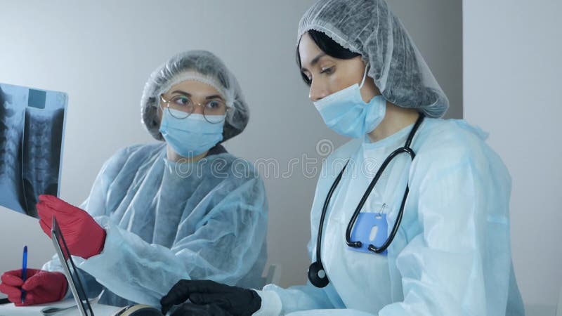 Young women professional laboratory scientist specialists working in modern clinical laboratory discussing medical