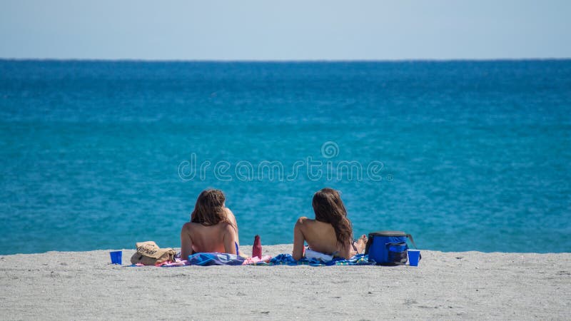 2 young women on the sand on a beach in Florida