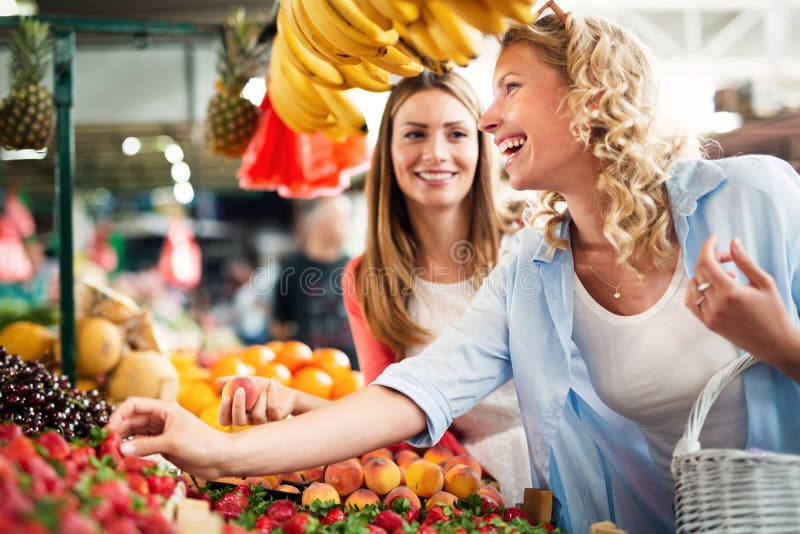 Young women shopping on the market healthy vegetables and fruits royalty free stock photography Young women shopping on the market healthy vegetables and fruits royalty free stock photography