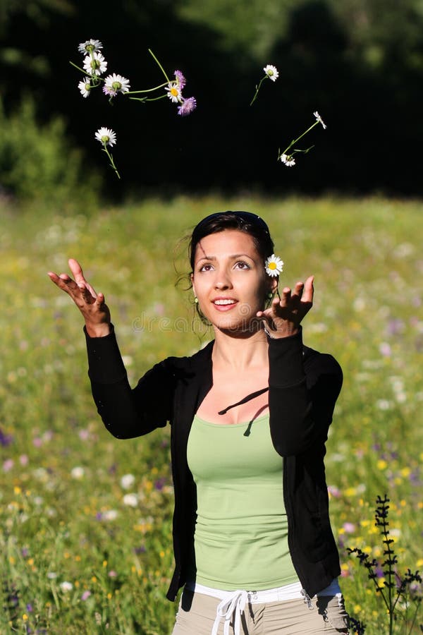 Young women throwing flowers into the air