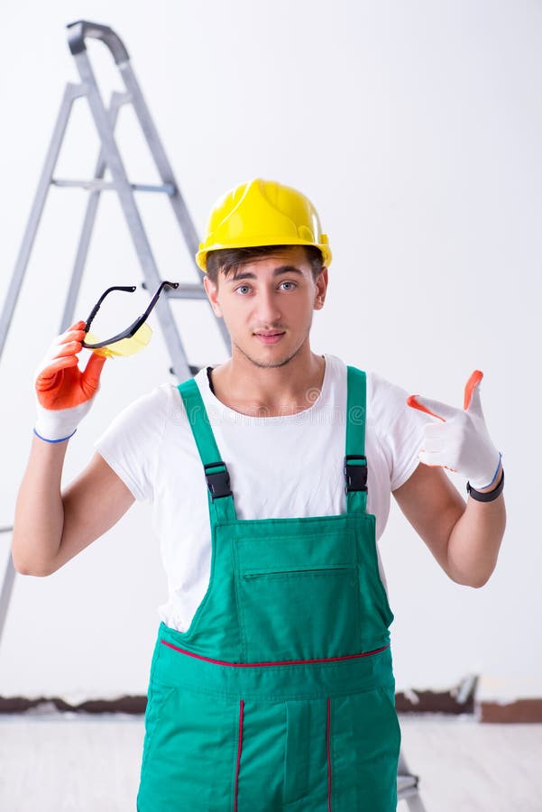 The Young Worker with Protective Equipment in Safety Concept Stock