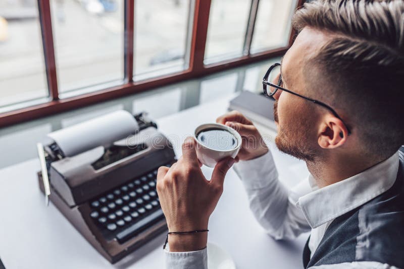 Young writer drinking coffee