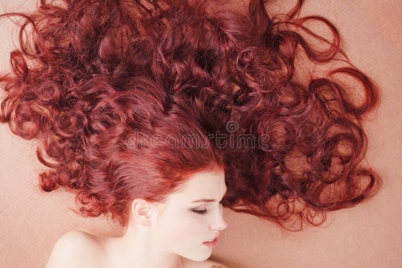 Young girl with long hair lying on the floor