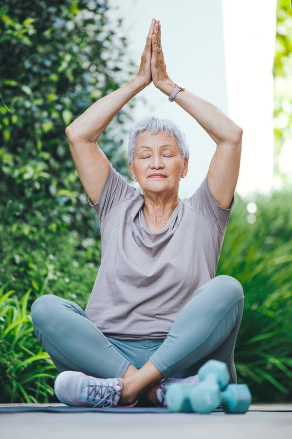 Youre never too old to find yourself. an older woman in deep meditation outside. stock photography