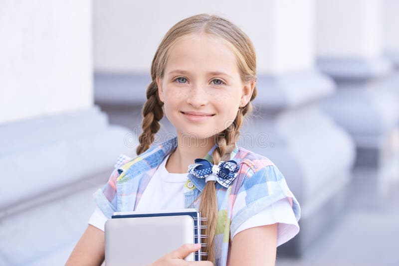 Youth schoolchild hug book in Casual uniform. Enter school stock photo Youth schoolchild hug book in Casual uniform. Enter school stock photo