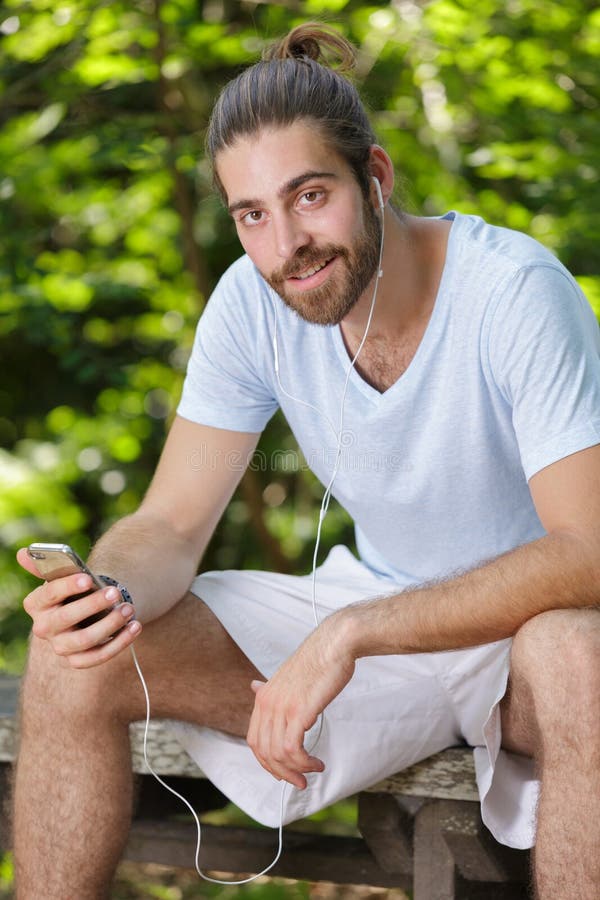 Youthful guy having break while training outdoor stock photography