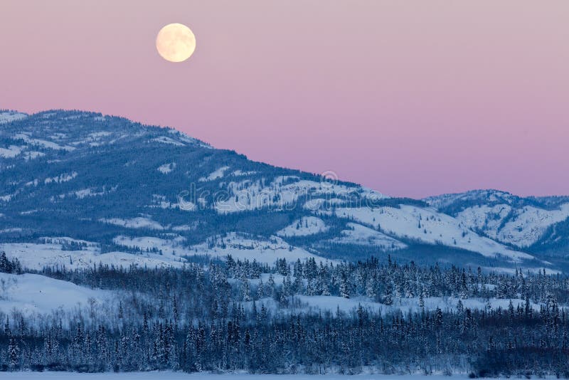 Yukon Canada winter landscape and full moon rising