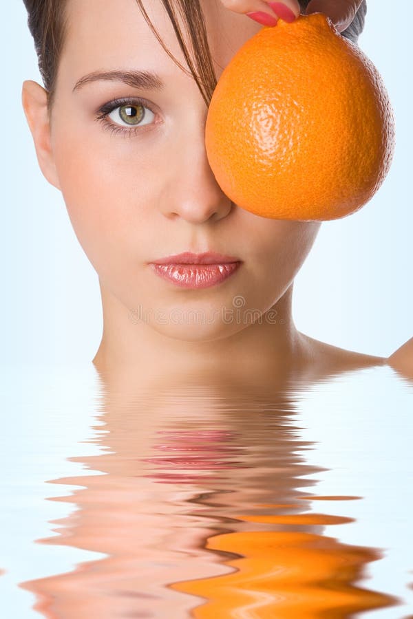 Yung beauty girl hold orange front of eye. Yung beauty girl hold orange front of eye