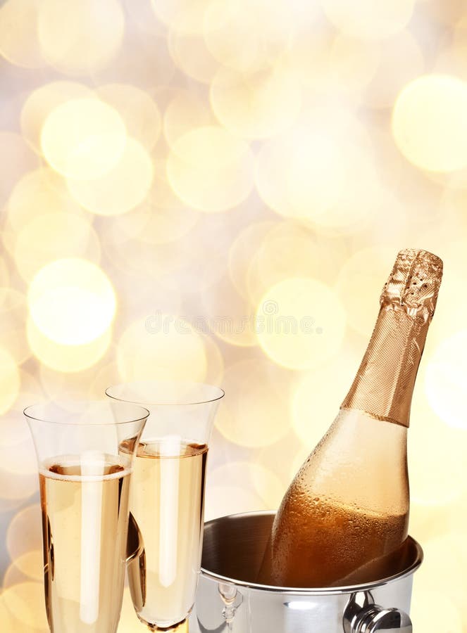 Two champagne glass with bottle on a yellow blur background. Two champagne glass with bottle on a yellow blur background.