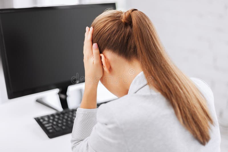 Business, office, school and education concept - stressed businesswoman with computer at work. Business, office, school and education concept - stressed businesswoman with computer at work