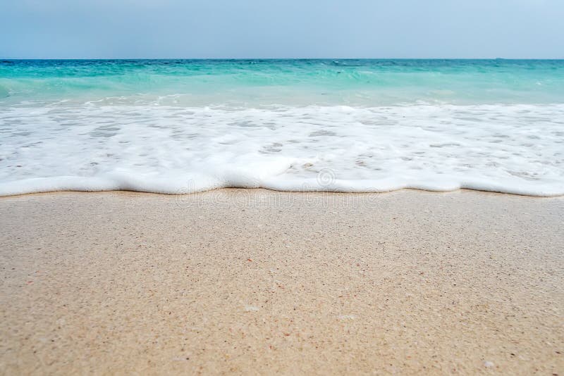 Zachte Blauwe Oceaangolf op Sandy Beach Achtergrond stock fotografie Zachte Blauwe Oceaangolf op Sandy Beach Achtergrond stock fotografie