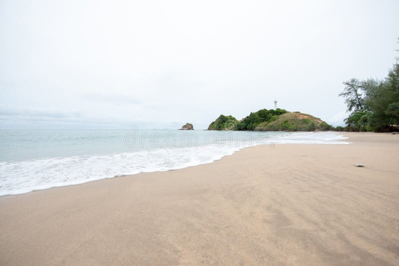 Soft waves on the sand beach. White bubbles created on the beach by ocean waves on seashore. Tropical beach with stream wave. Soft waves on the sand beach. White bubbles created on the beach by ocean waves on seashore. Tropical beach with stream wave.