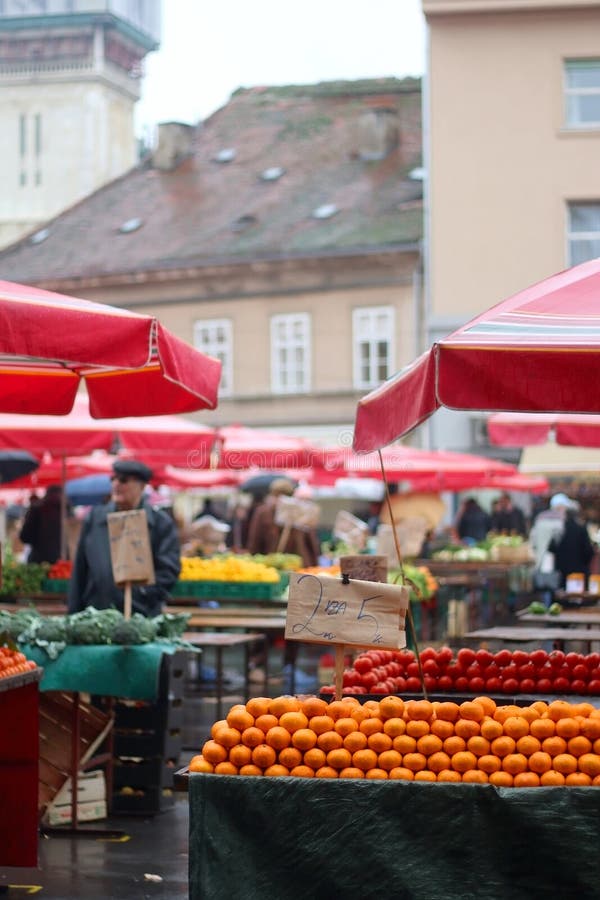 Market in Zagreb, Croatia. Zagreb, Croatia - November 27, 2016: Fresh oranges for sale on traditional Dolac market in zagreb, Croatia. People in the background stock photos Market in Zagreb, Croatia. Zagreb, Croatia - November 27, 2016: Fresh oranges for sale on traditional Dolac market in zagreb, Croatia. People in the background stock photos