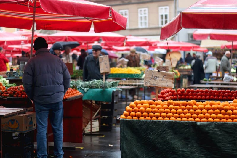 Market in Zagreb, Croatia. Zagreb, Croatia - November 27, 2016: Fresh oranges for sale on traditional Dolac market in zagreb, Croatia. People in the background royalty free stock photo Market in Zagreb, Croatia. Zagreb, Croatia - November 27, 2016: Fresh oranges for sale on traditional Dolac market in zagreb, Croatia. People in the background royalty free stock photo