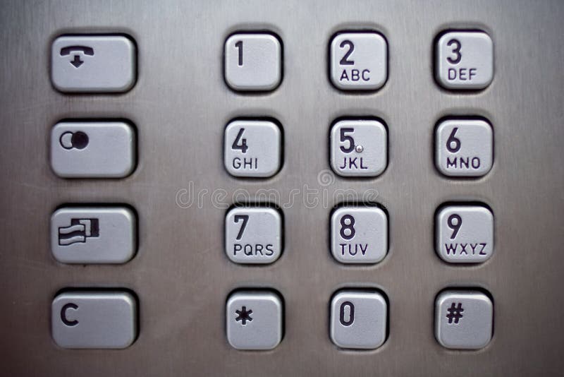 Metallic number pad on a public phone. Metallic number pad on a public phone