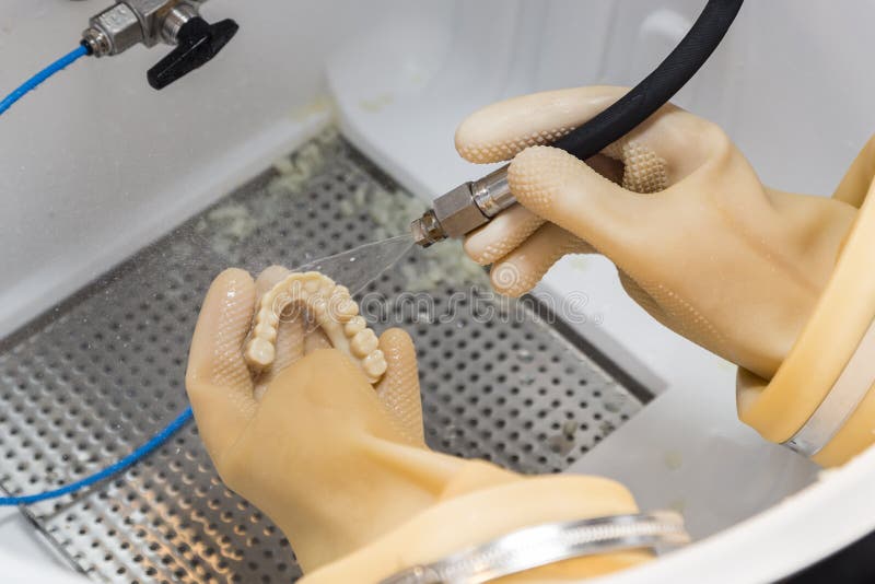 Male Dental Technician Working On A 3D Printed Mold For Tooth Implants In The Lab. Male Dental Technician Working On A 3D Printed Mold For Tooth Implants In The Lab.