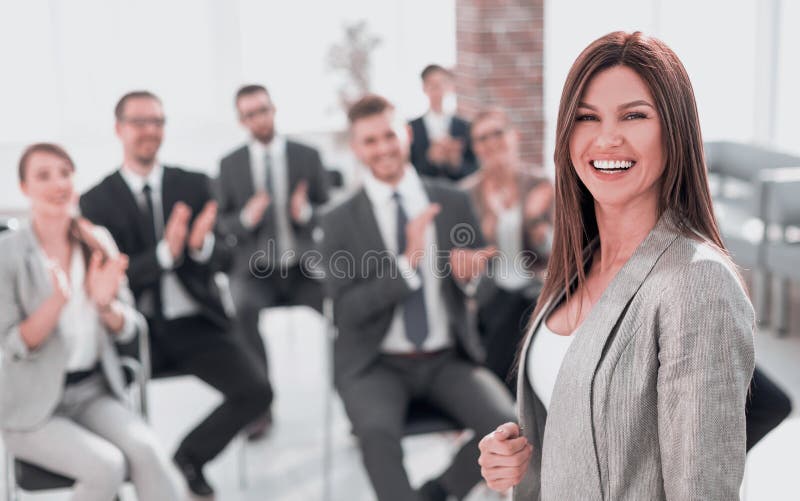 Young business women on the background of applauding business team.photo with copy space. Young business women on the background of applauding business team.photo with copy space