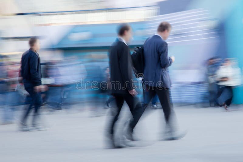 Intentionally motion blurred image of businessmen rushing to office in the morning. Intentionally motion blurred image of businessmen rushing to office in the morning